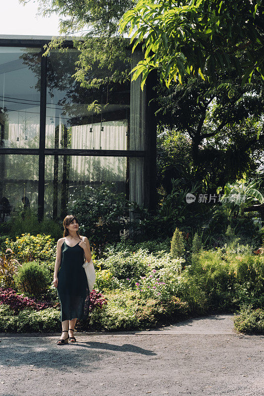 美丽的年轻女子站在曼谷的植物园