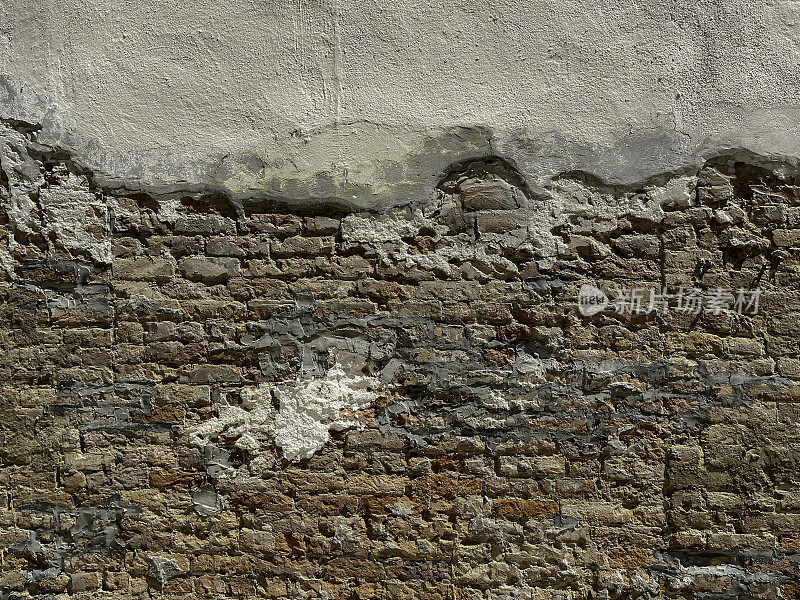老旧的红砖墙，背景是白色的灰泥