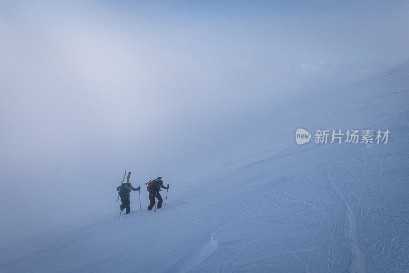 滑雪登山运动员攀登积雪的山脊线