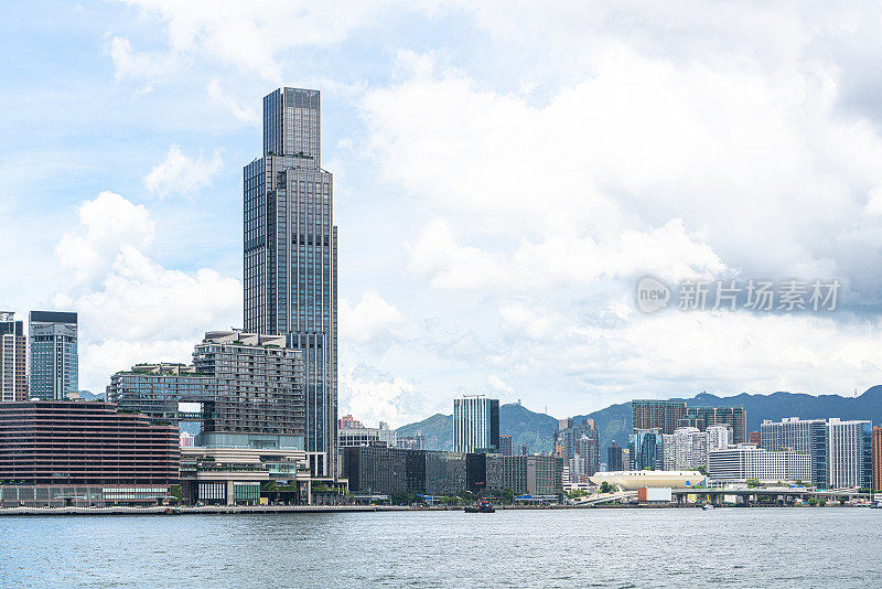 在一个阳光明媚的日子里，从香港维多利亚港对面眺望尖沙咀的九龙天际线