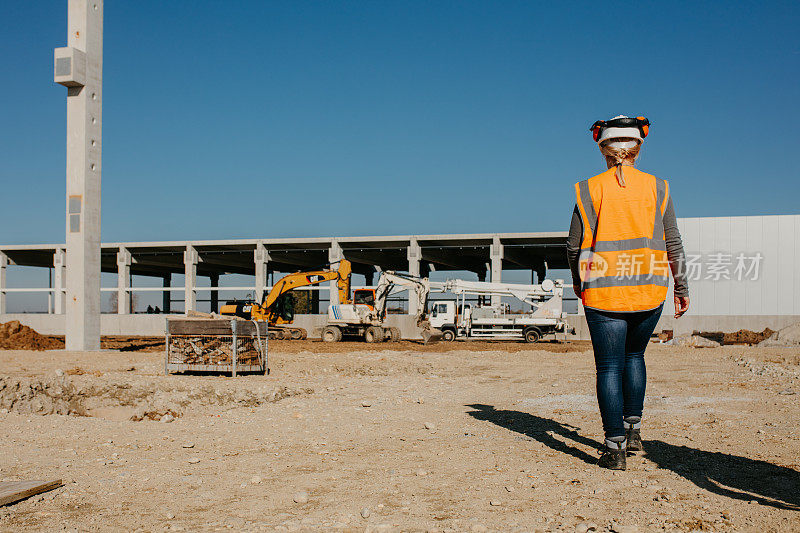 女建筑师在建筑工地行走