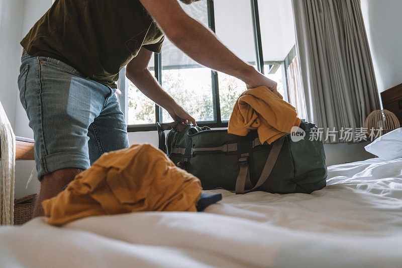 男性旅行者打包旅行时，会把衣服放在行李袋里