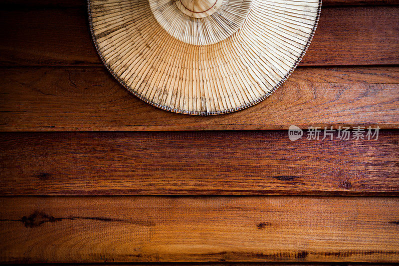 农民帽子编织棕榈叶挂在古董乡村木制背景，复制空间