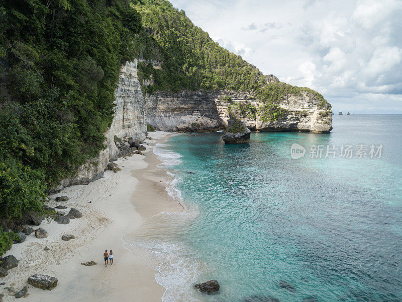 鸟瞰热带海滩上的年轻情侣享受度假和大自然，人们旅游探险的理念