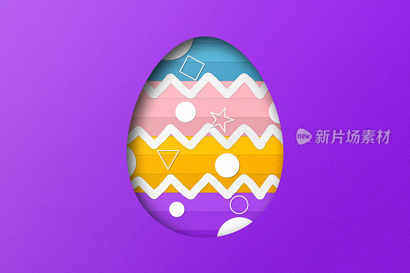 紫色和黄色的剪纸形成了复活节彩蛋的图案。覆盖纸