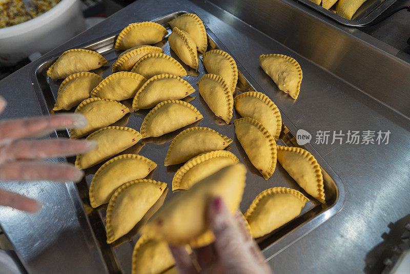 拉丁裔员工在一家小型肉馅卷饼食品公司的厨房里