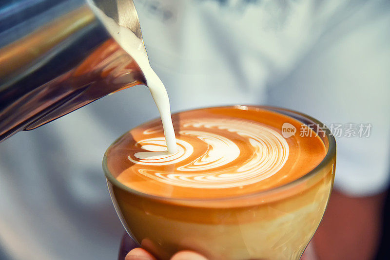 咖啡师在咖啡店和餐厅用咖啡机准备新鲜的咖啡或拉花艺术并倒入杯子