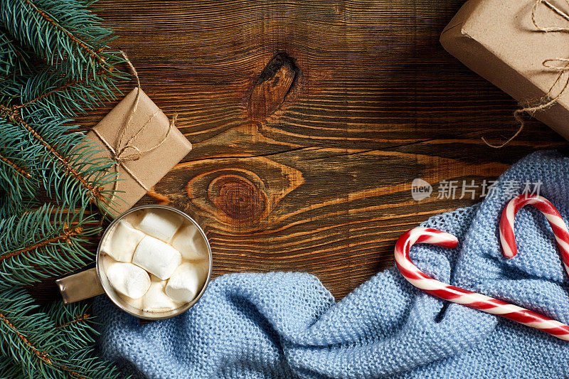 圣诞节喝。用马克杯热咖啡和棉花糖，红色拐杖糖在木制的背景。新的一年