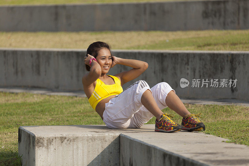 亚洲年轻女子在户外公园积极锻炼