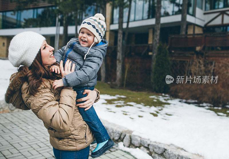 妈妈快乐，儿子在雪天玩得开心