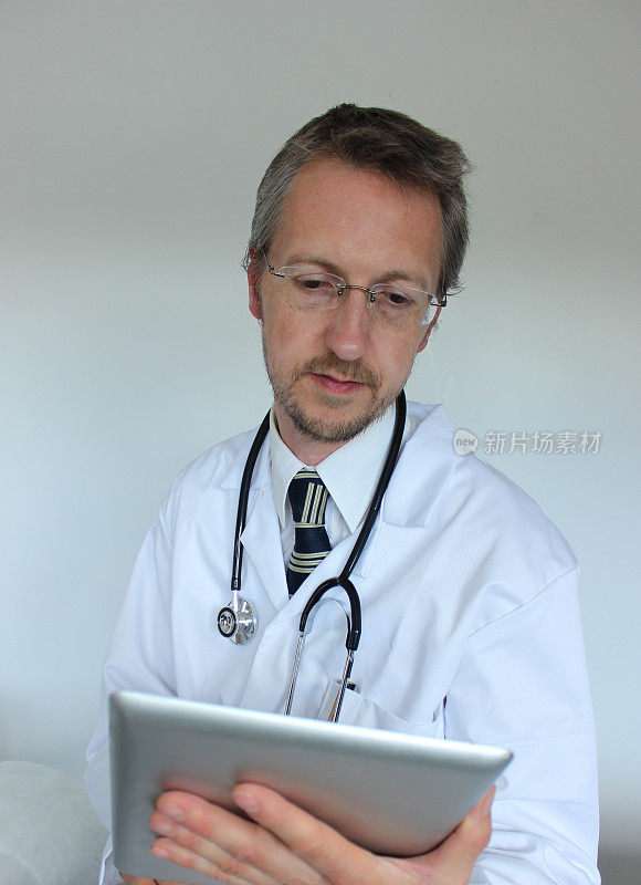 年轻的医院医生在电脑屏幕上检查结果