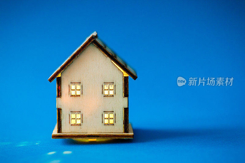 蓝色背景的木制模型房子