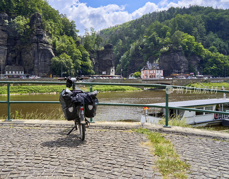 在一个可以看到易北河对岸捷克村庄赫伦斯科的平台上，骑自行车的人带着提包，捷克共和国自行车之旅