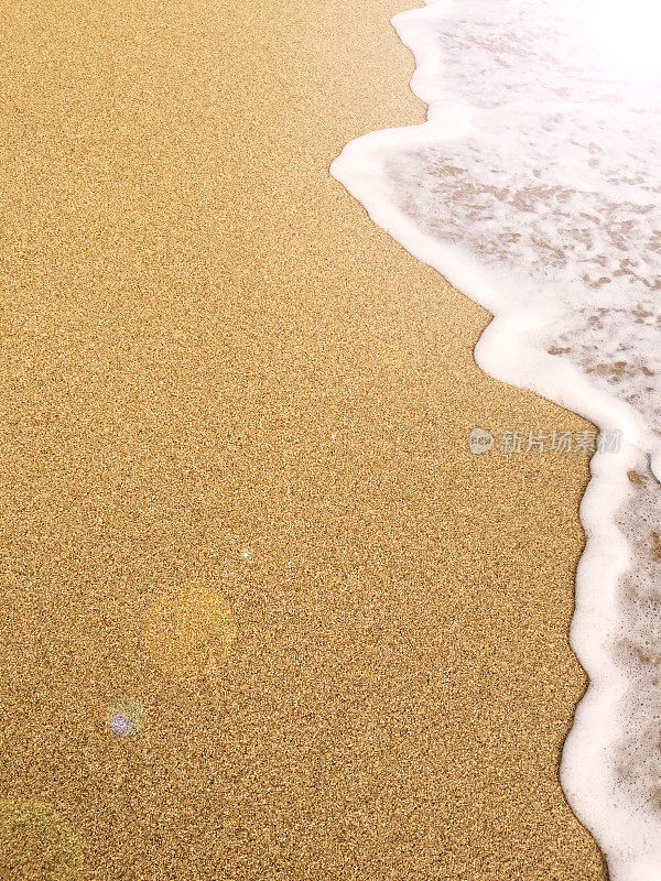 金色的沙滩和泡沫的海浪