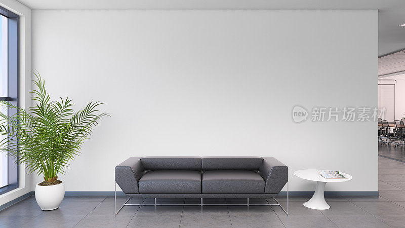 现代办公室内，黑色沙发前面是空白的白墙