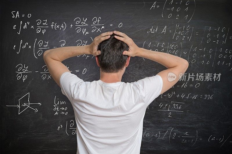 一个年轻人正在黑板上解数学题，他很困惑。