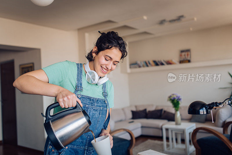 一个快乐的女孩在早上煮咖啡的肖像