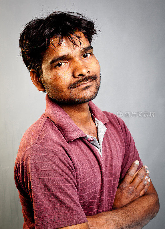 乡村印度年轻男性的肖像在垃圾墙