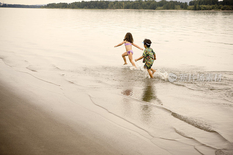 可爱的孩子在海滩上跑步，宽镜头，复制空间