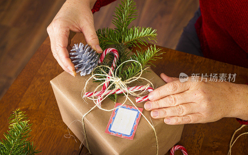 女人用牛皮纸和麻绳包装圣诞礼物