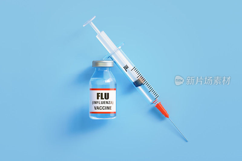 蓝色背景的流感疫苗和注射器