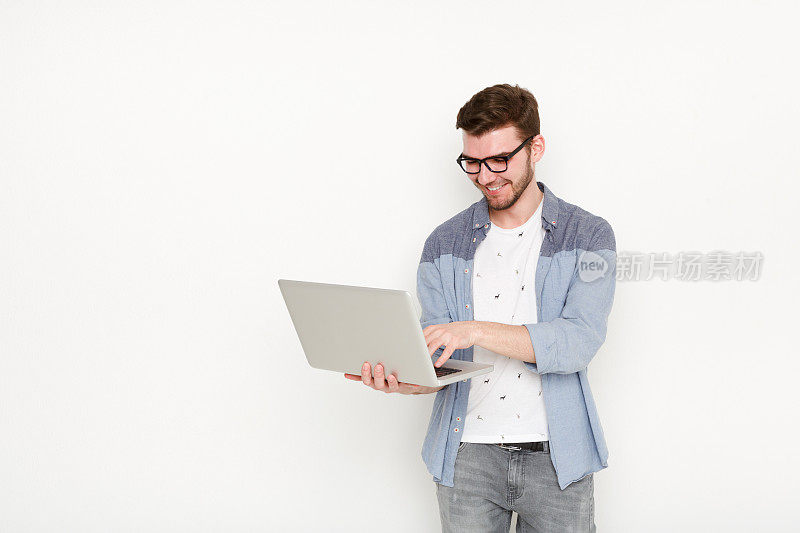 年轻人拿着笔记本电脑