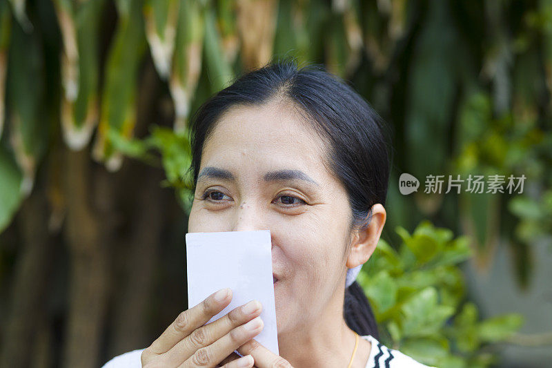 微笑的泰国女子亲吻中奖彩票
