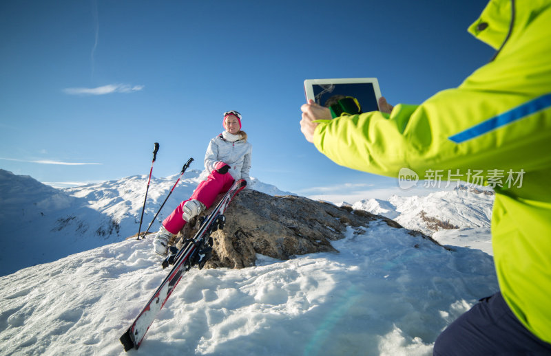 山顶上的女人在为数码平板电脑摆姿势