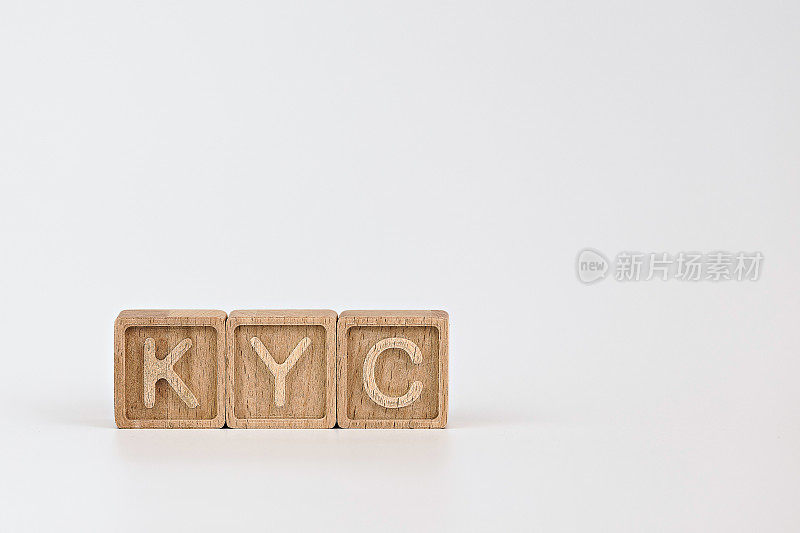 KYC了解您在金融服务主题方面的客户指导方针。白色背景上刻有KYC首字母缩写的木制立方体