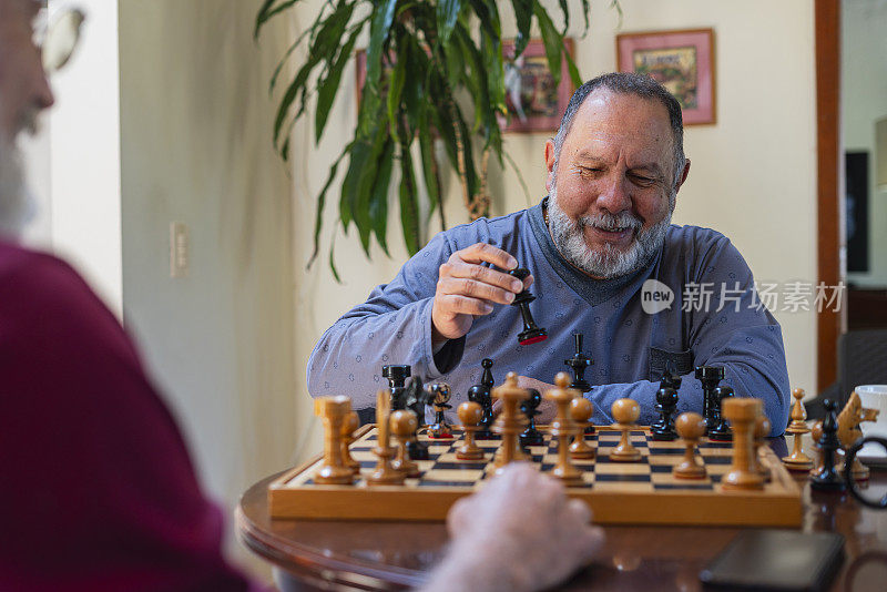 住在同一家疗养院的拉丁裔男人在一起下棋，分散注意力。