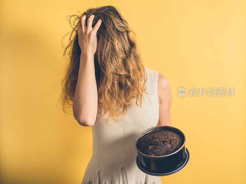 一个女人用烧焦的蛋糕拉她的头发