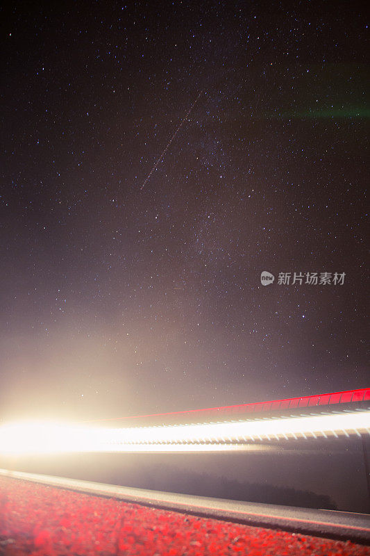 乡间小路上美丽而抽象的车灯。车流在夜里，从路边看过去。
