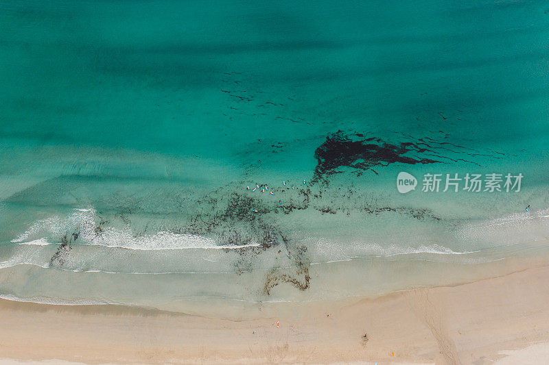 航拍的海滩与冲浪者在水晶蓝色的海在挪威