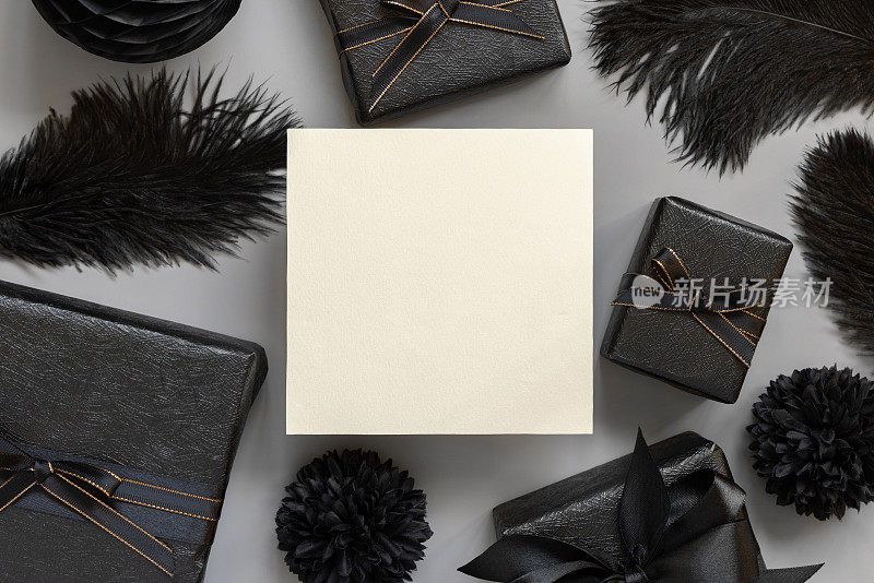方形空白卡之间包装礼盒，黑色纸花和羽毛，模型