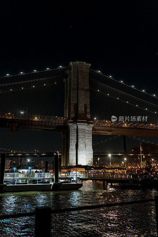 夜晚的纽约布鲁克林大桥。大都市的摩天大楼。夜城长曝光。大城市的高楼大厦。