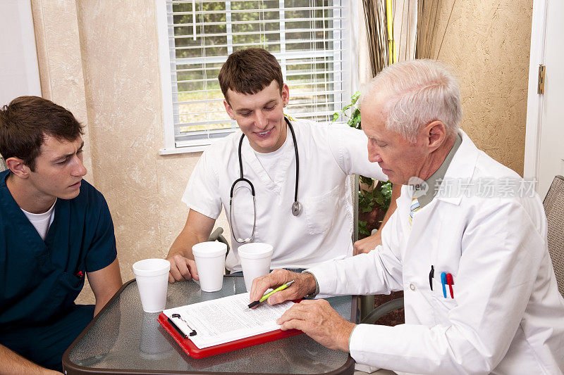 资深医师在医院指导年轻实习生。医疗工作人员。