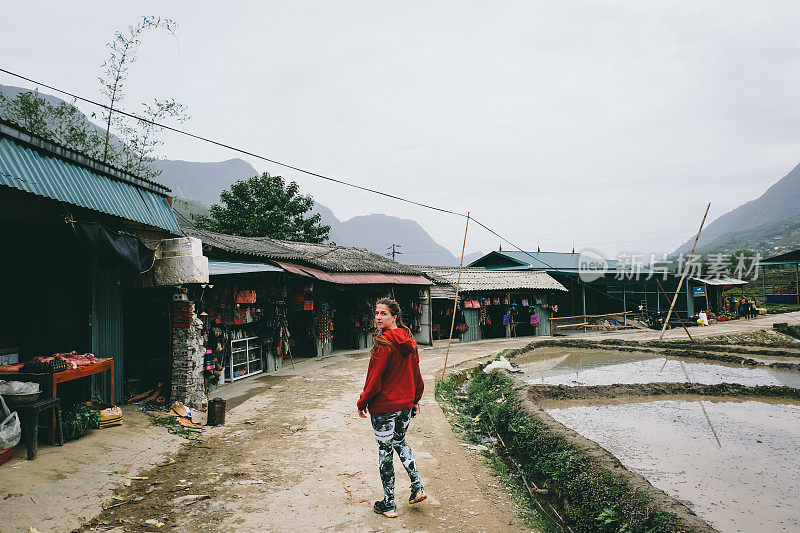 一名妇女走在越南北部的山村市场上