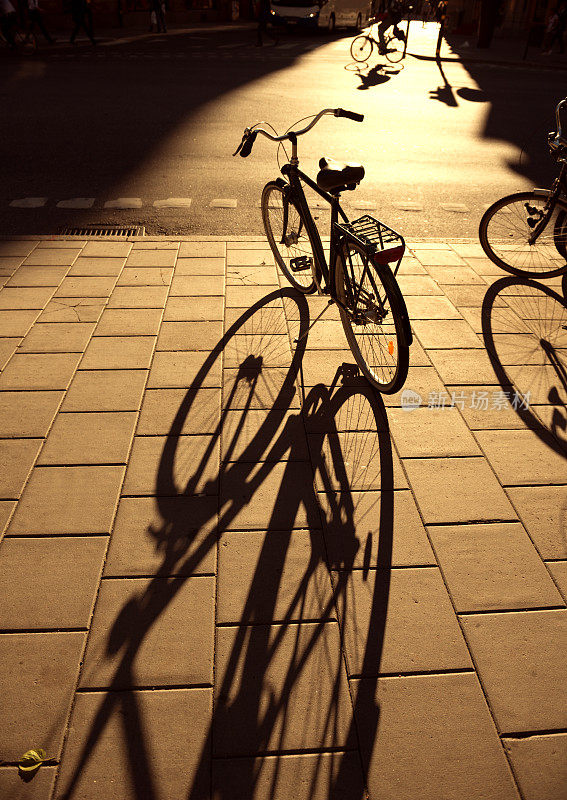 自行车停在人行道上。最后一束秋日的光芒。