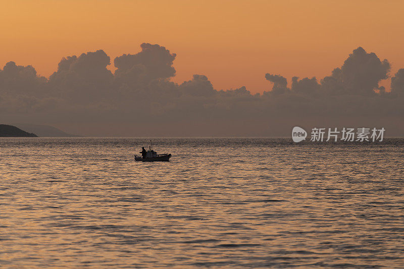 日出时分，爱琴海上，一位希腊渔夫驾着他的小船