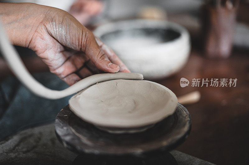 观女手作品用陶土制作未来陶瓷板，陶瓷艺术家在现代陶艺作坊制作班手建筑，创意人士手工设计