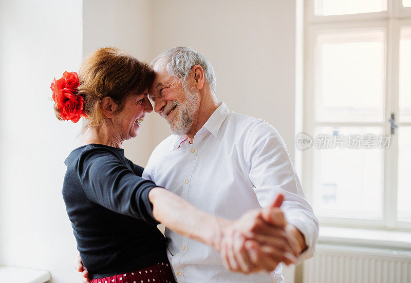 一对老年夫妇在社区中心上舞蹈课。