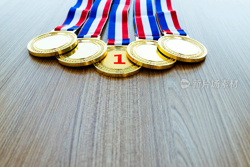 五枚金牌放在木桌上