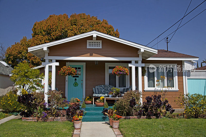 郊区的棕色房子，蓝色的门在一个阳光明媚的日子