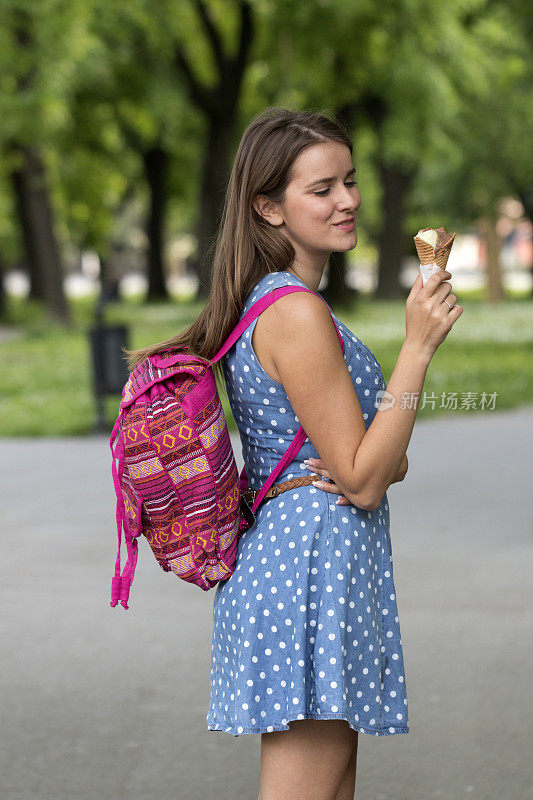 在公园散步吃冰淇淋的好女孩