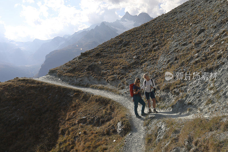 当道路分叉时，两个徒步旅行者在看地图