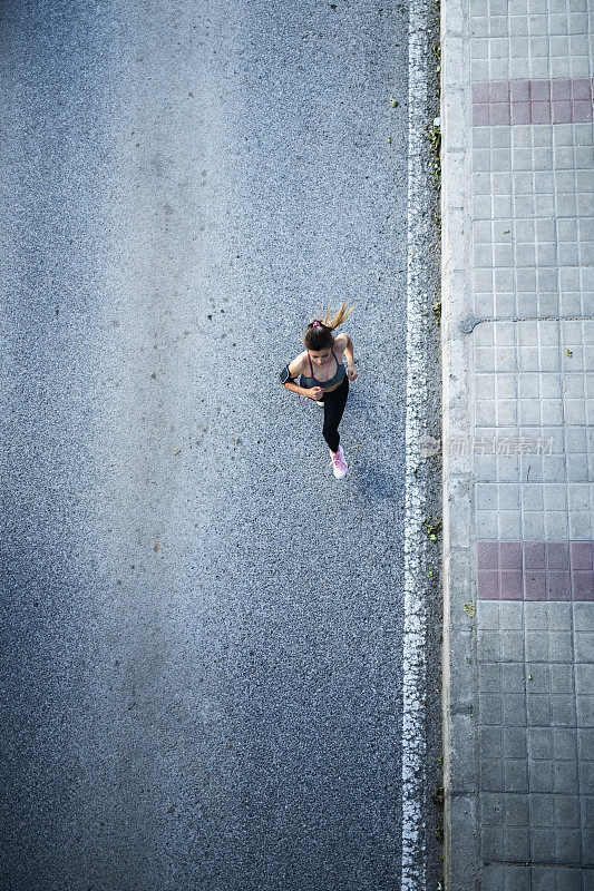 女人在街上奔跑的鸟瞰图。