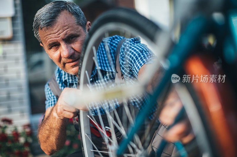 成熟男子修自行车