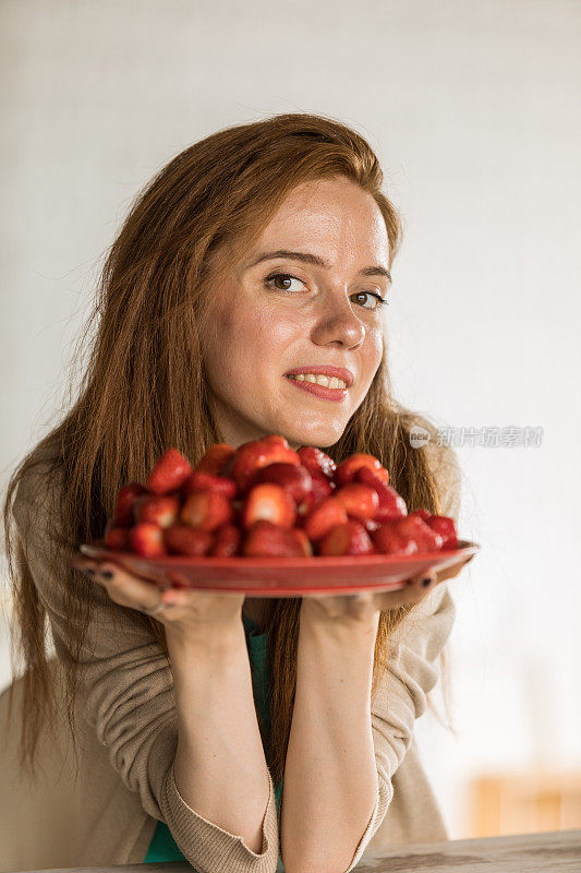 给年轻女子盛了一盘草莓