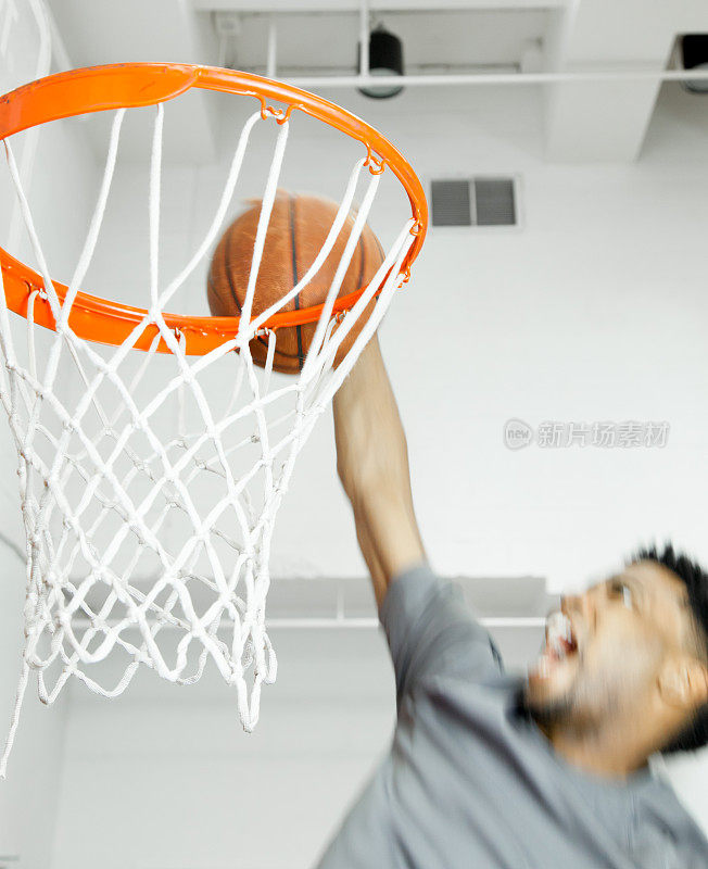 一个30岁的美国黑人在体育馆打篮球