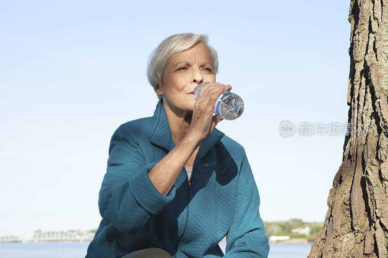 在外面喝水的老妇人